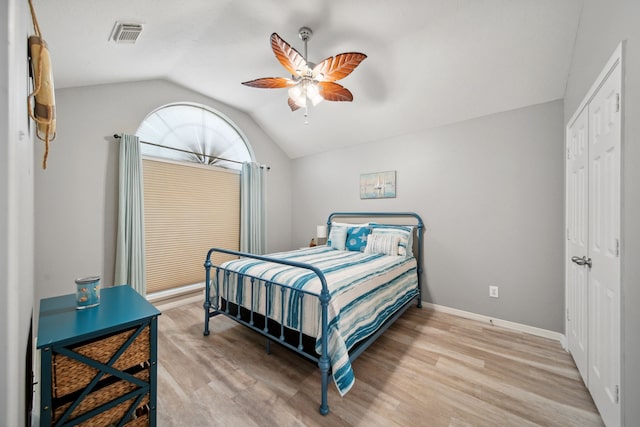 12858 Pelican Island Dr, Willis, TX 77318 - bedroom with visible vents, lofted ceiling, baseboards, ceiling fan, and light wood finished floors