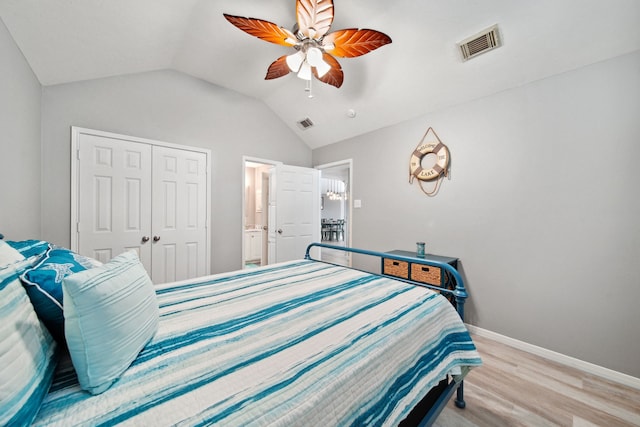 12858 Pelican Island Dr, Willis, TX 77318 - bedroom featuring baseboards, wood finished floors, lofted ceiling, visible vents, and a closet