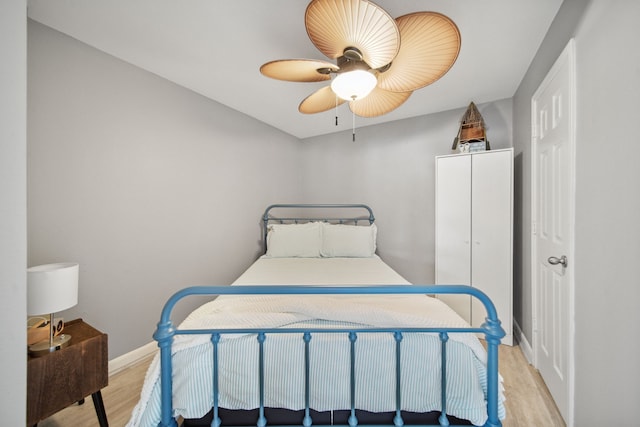 12858 Pelican Island Dr, Willis, TX 77318 - bedroom with a ceiling fan, baseboards, and light wood-style floors