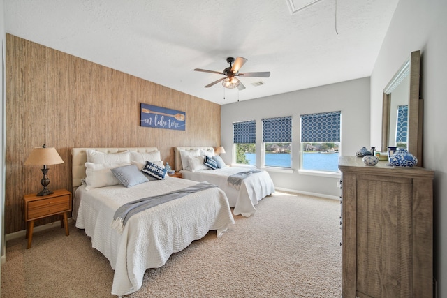 12858 Pelican Island Dr, Willis, TX 77318 - carpeted bedroom featuring baseboards, attic access, a ceiling fan, and visible vents
