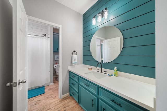 12858 Pelican Island Dr, Willis, TX 77318 - full bath featuring vanity, wood finished floors, curtained shower, toilet, and wooden walls