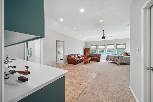 12858 Pelican Island Dr, Willis, TX 77318 - living room with light carpet, baseboards, ceiling fan, recessed lighting, and a textured ceiling