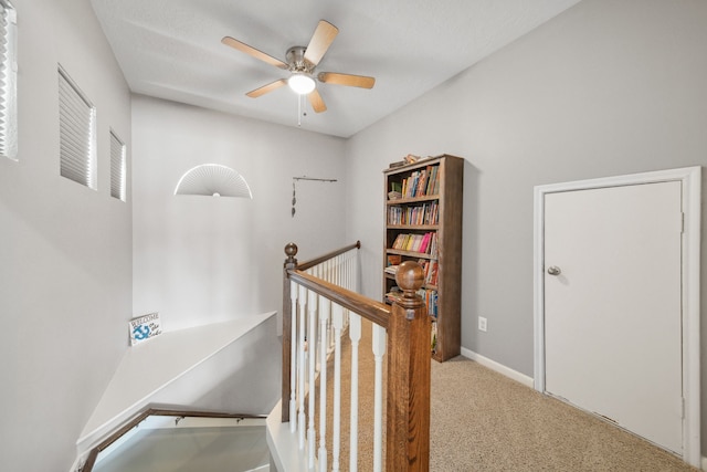 12858 Pelican Island Dr, Willis, TX 77318 - hallway featuring baseboards, carpet, and an upstairs landing