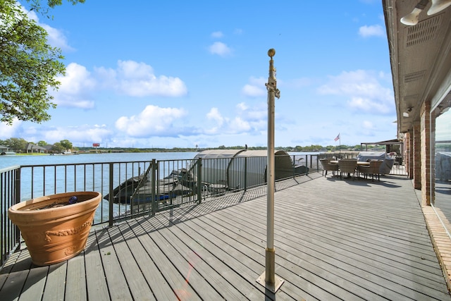12858 Pelican Island Dr, Willis, TX 77318 - wooden terrace with a water view and outdoor dining space