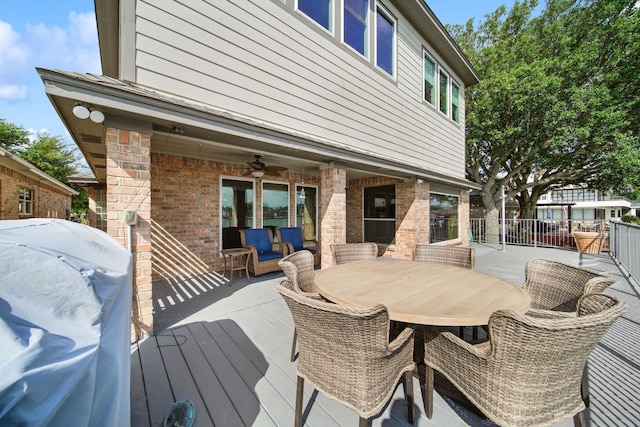 12858 Pelican Island Dr, Willis, TX 77318 - wooden deck with a ceiling fan, outdoor dining area, and grilling area