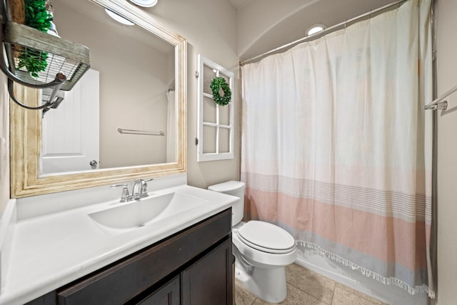 bathroom featuring toilet, tile patterned flooring, and vanity