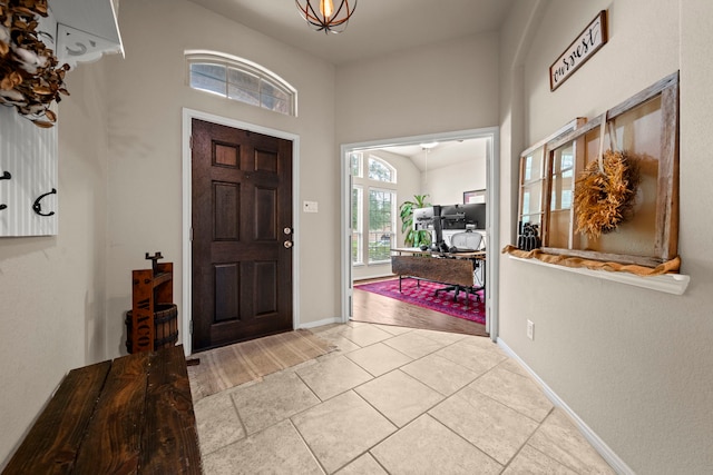tiled foyer entrance with baseboards