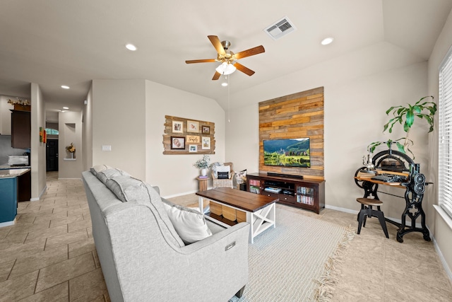 living room with a ceiling fan, visible vents, vaulted ceiling, baseboards, and recessed lighting