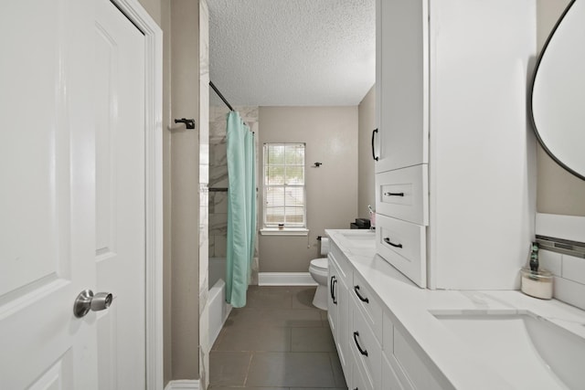 full bath with tile patterned flooring, vanity, toilet, baseboards, and a textured ceiling
