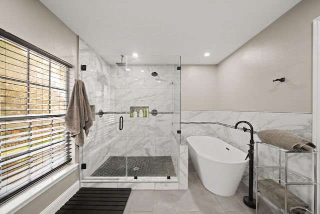 full bath with a freestanding bath, wainscoting, recessed lighting, tile walls, and a shower stall