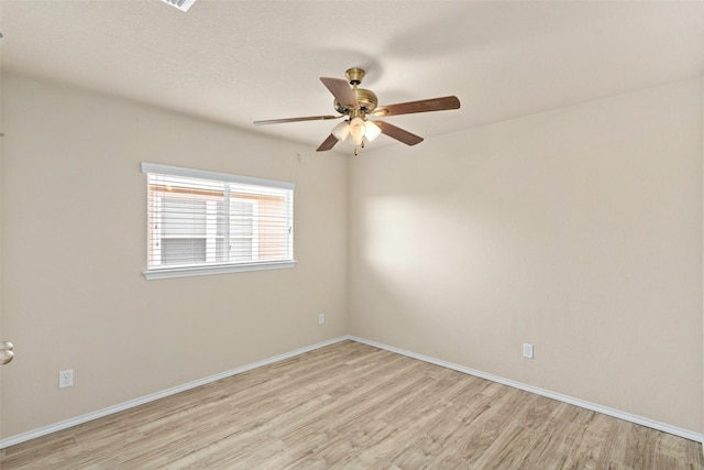 unfurnished room with baseboards, light wood finished floors, and ceiling fan