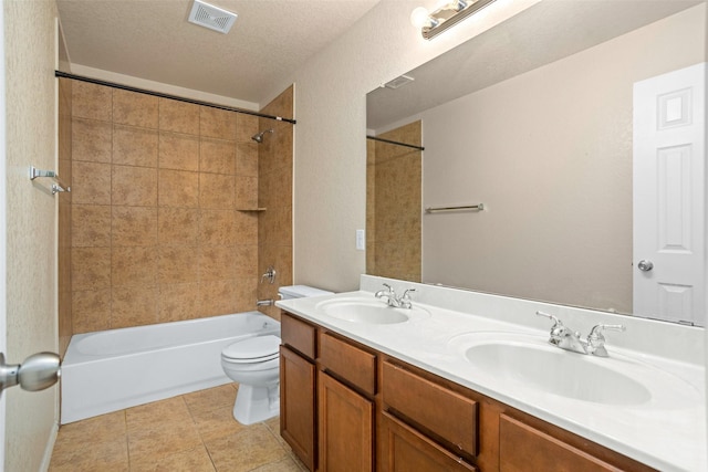 bathroom featuring double vanity, toilet, visible vents, and a sink