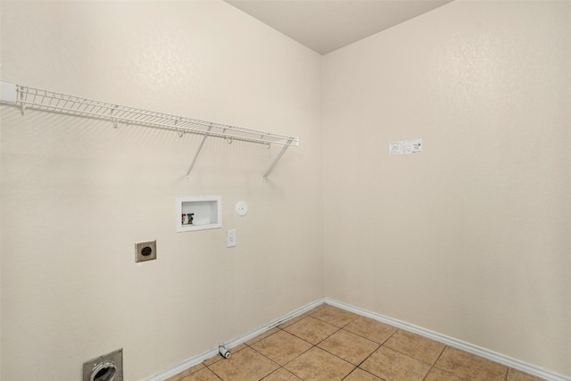washroom with light tile patterned flooring, laundry area, hookup for a washing machine, electric dryer hookup, and baseboards