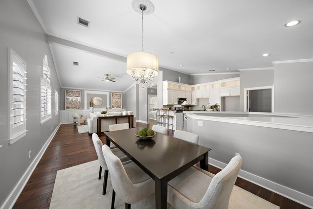 dining area with visible vents, ornamental molding, dark wood-style floors, recessed lighting, and ceiling fan with notable chandelier