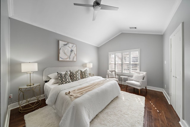 bedroom with dark wood-style flooring, visible vents, crown molding, vaulted ceiling, and baseboards