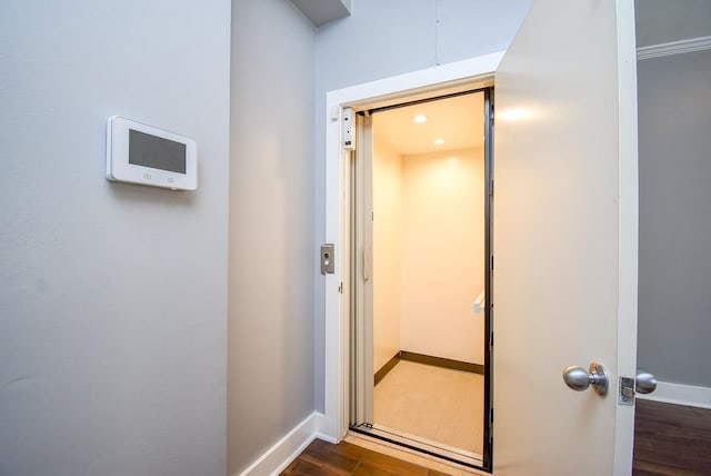 interior space featuring baseboards and wood finished floors