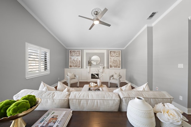 living room with crown molding, ceiling fan, lofted ceiling, and visible vents