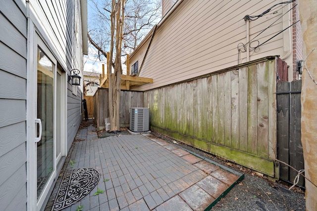 view of patio / terrace featuring central AC and fence