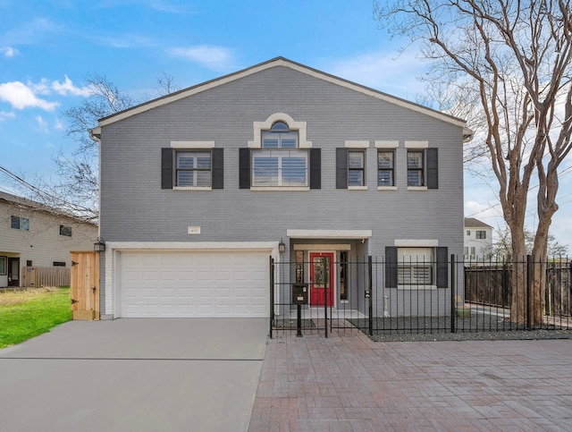 traditional home with a fenced front yard, a gate, brick siding, concrete driveway, and an attached garage