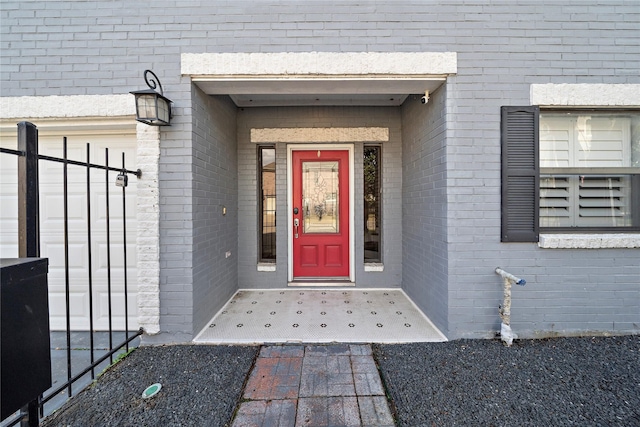 entrance to property featuring brick siding