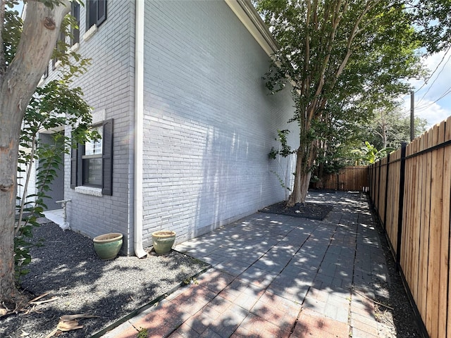 4917 Eigel St, Houston, TX 77007 - view of home's exterior featuring brick siding, a fenced backyard, and a patio area