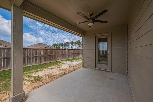 view of patio with fence and a ceiling fan