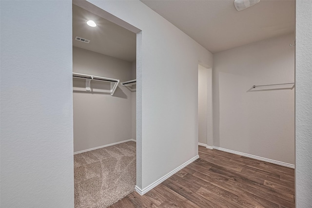 spacious closet featuring visible vents and wood finished floors