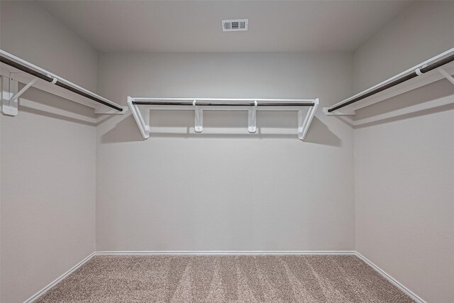 walk in closet with visible vents and carpet flooring
