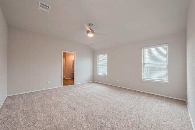 carpeted spare room with a ceiling fan, baseboards, and visible vents
