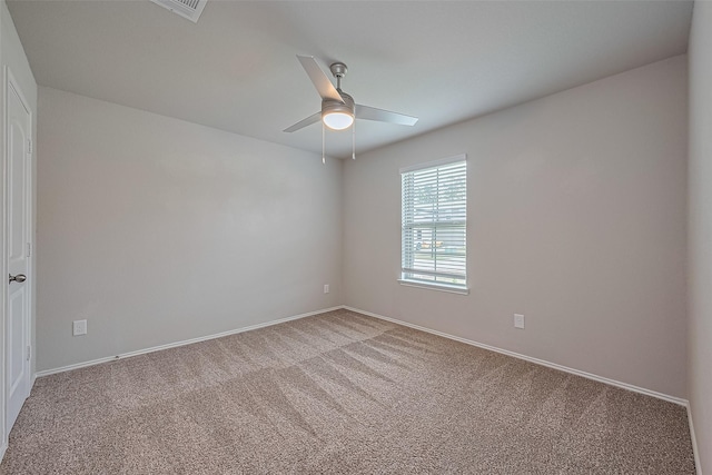 spare room featuring baseboards, carpet, and ceiling fan