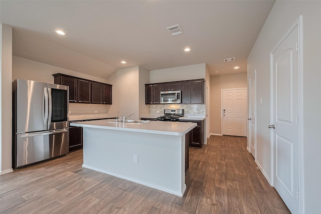 kitchen with a sink, light countertops, stainless steel appliances, and visible vents