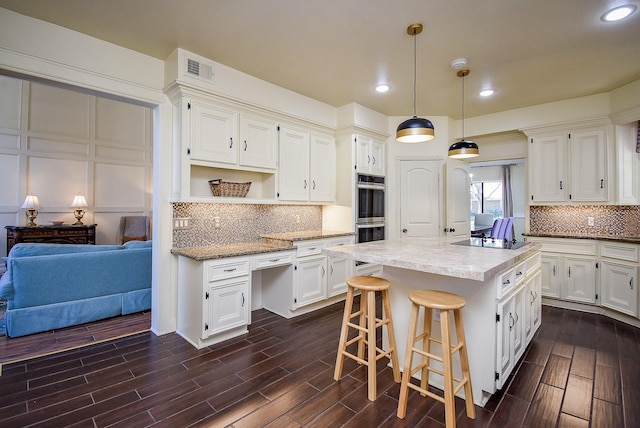 kitchen with open shelves, a kitchen island, dark wood-style floors, white cabinets, and backsplash