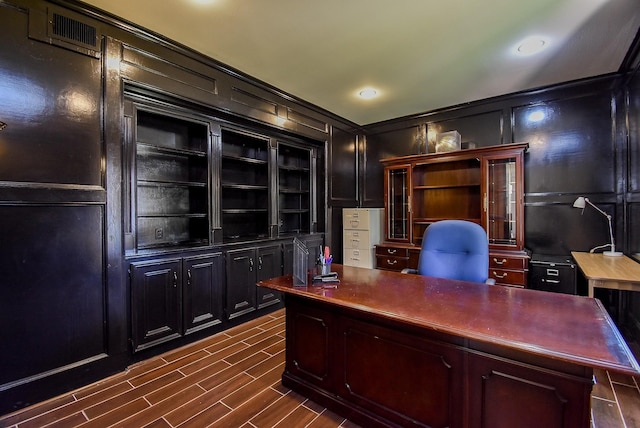 office space with crown molding, recessed lighting, and a decorative wall