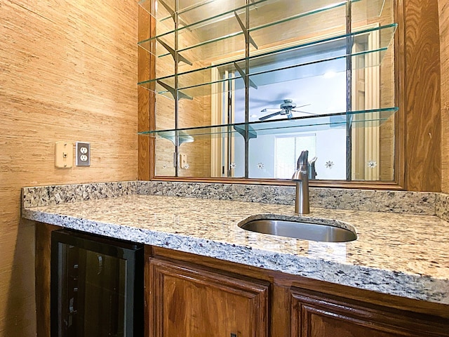bar featuring wine cooler, ceiling fan, and a sink