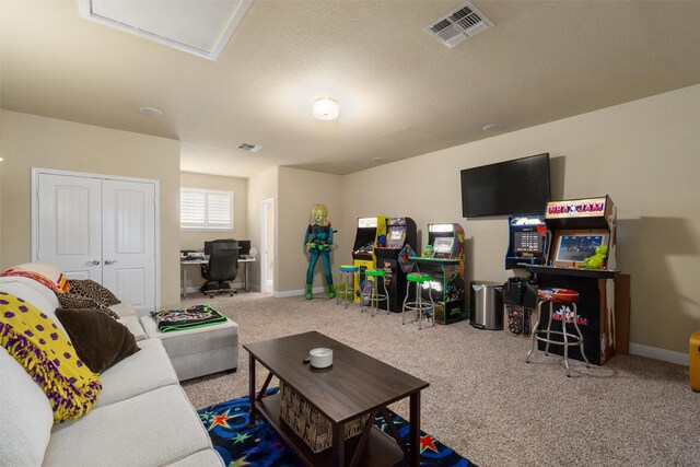 carpeted living area featuring baseboards and visible vents