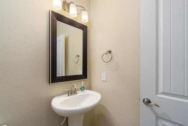 bathroom with a sink and a textured wall