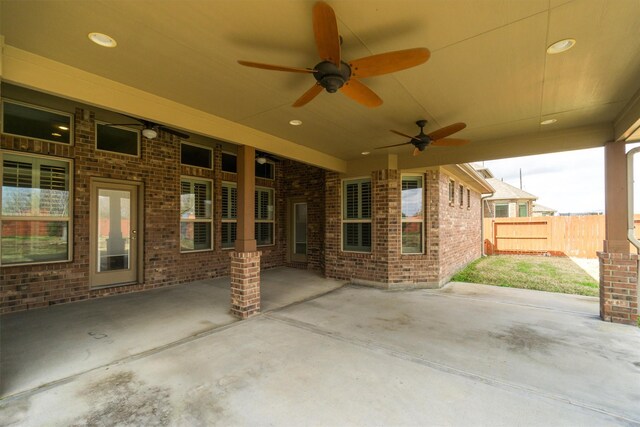 view of patio featuring ceiling fan and fence