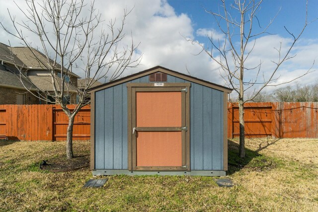 view of shed with a fenced backyard