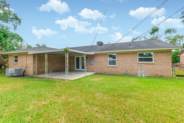 4314 Woodmont Dr, Houston, TX 77045 - back of house featuring central air condition unit, a lawn, a patio area, and french doors