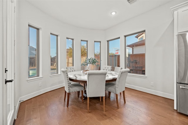 dining area with baseboards, recessed lighting, wood finished floors, and visible vents