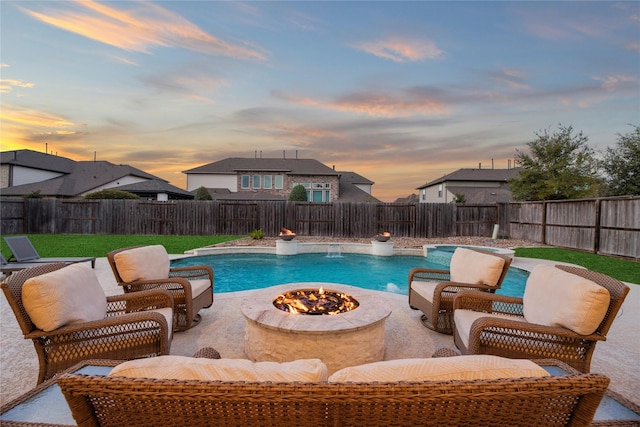view of pool featuring a fenced backyard, an outdoor fire pit, and a patio area