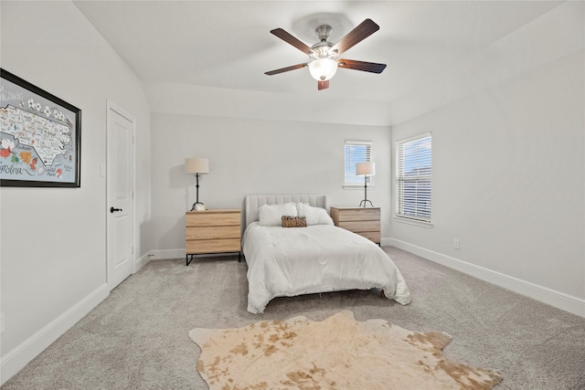 carpeted bedroom featuring baseboards and a ceiling fan