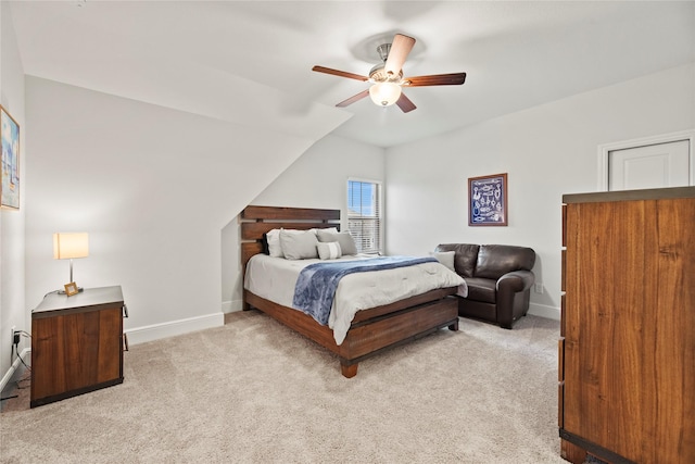 bedroom featuring baseboards, a ceiling fan, vaulted ceiling, and light carpet