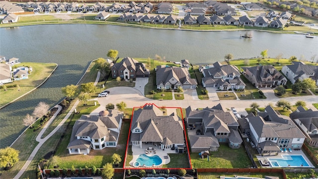 drone / aerial view with a residential view and a water view