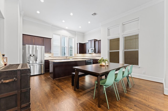 dining room featuring dark wood finished floors, ornamental molding, recessed lighting, and visible vents