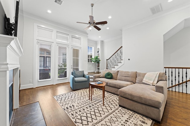 living area featuring visible vents, a ceiling fan, a fireplace with flush hearth, and recessed lighting