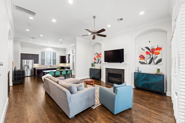 living room featuring crown molding, recessed lighting, and visible vents
