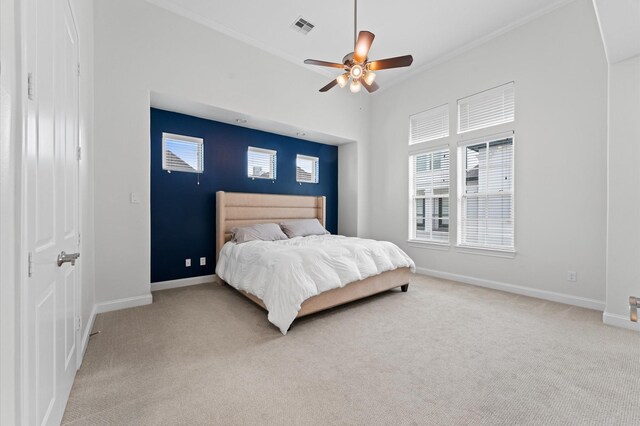 carpeted bedroom featuring crown molding, baseboards, and visible vents