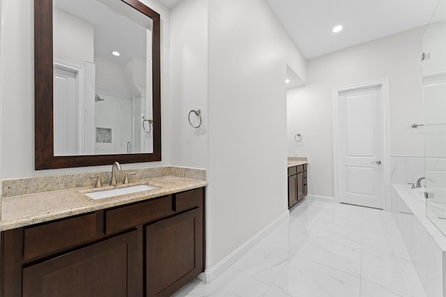 full bathroom featuring a garden tub, a shower stall, vanity, baseboards, and marble finish floor