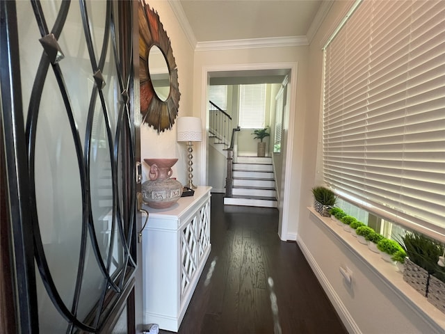 corridor with crown molding, dark wood-style flooring, baseboards, and stairway